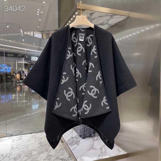 Chanel Reversible Cape Shawl—A Classic That Never Goes Out of Style. One side features a simple, matte black design.
